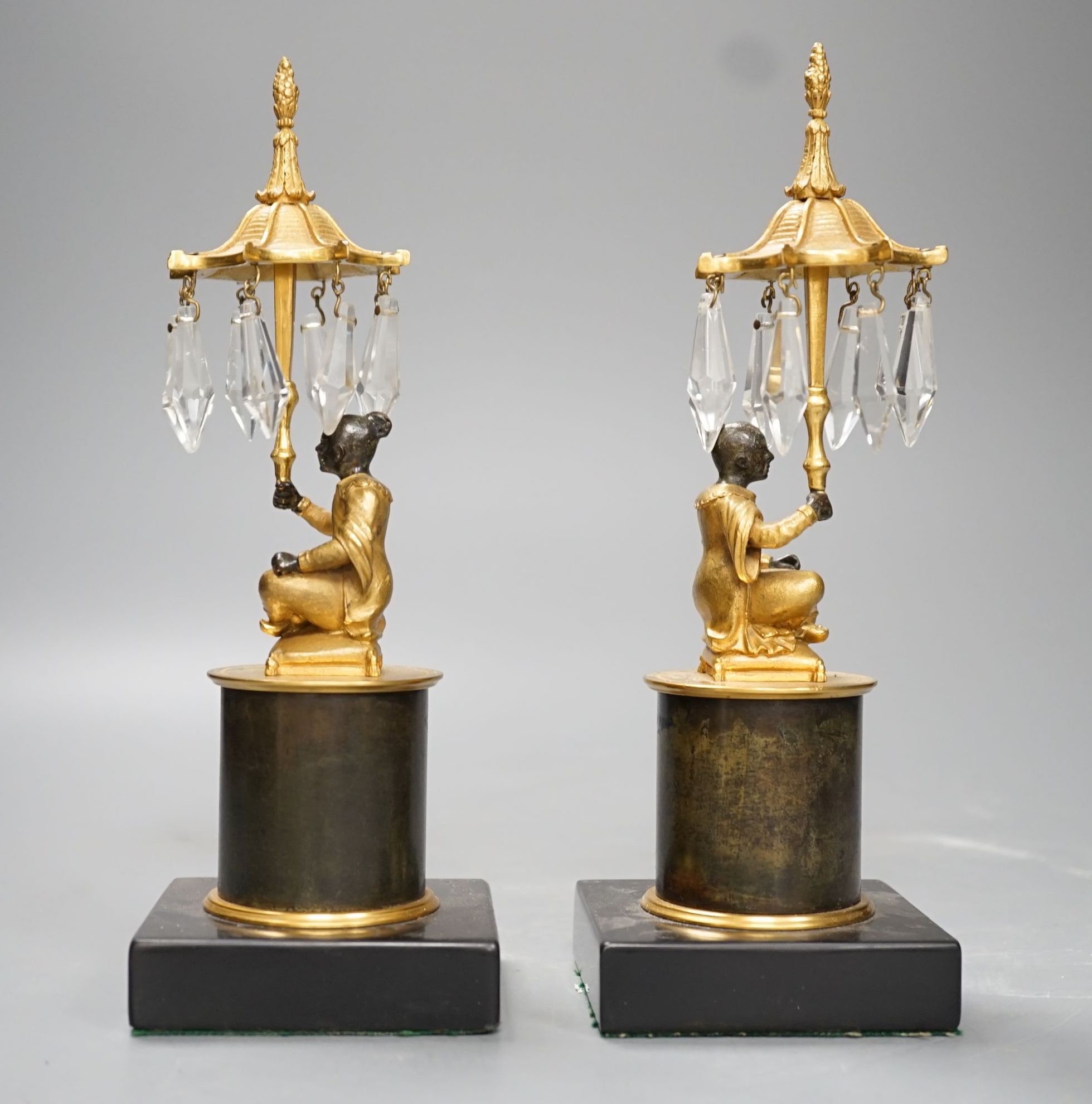 A pair of Louis XVI style bronze chinoiserie lustres depicted plinth seated gentleman bearing umbrella lustre drops - 23cm tall